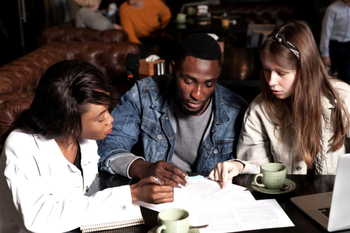 Students analyzing financial data and budget reports in a collaborative learning environment